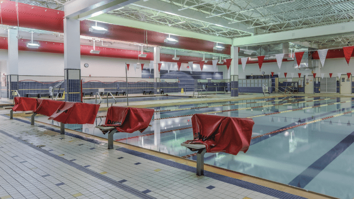 Lap pool with diving blocks covered.